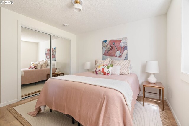 12620 NW Barnes Rd, Portland, OR 97229 - bedroom with light wood-style floors and a closet