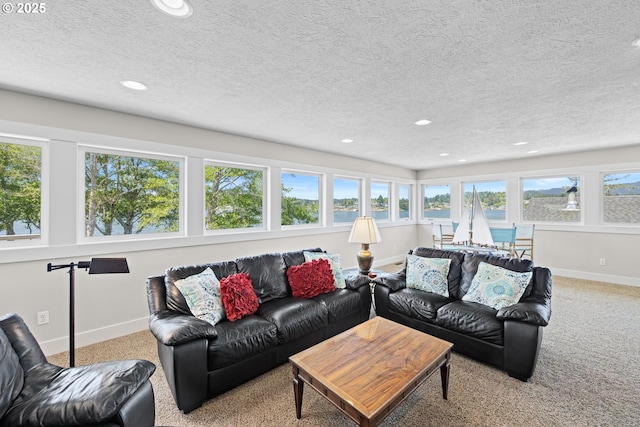 2941 NE Loop Dr, Otis, OR 97368 - carpeted living area featuring recessed lighting, baseboards, a textured ceiling, and a water view