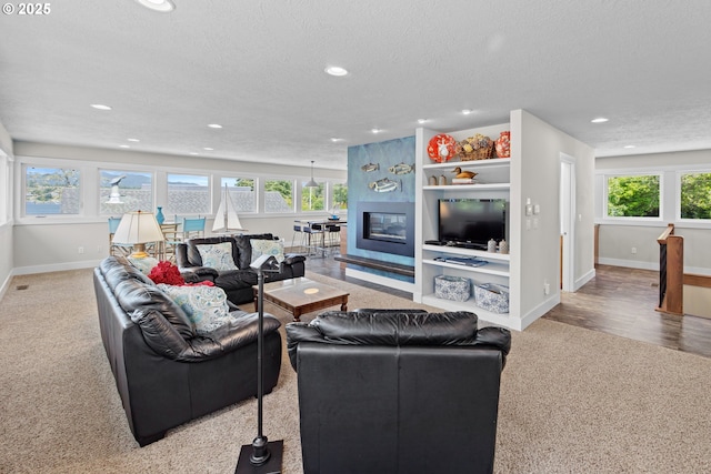 2941 NE Loop Dr, Otis, OR 97368 - living area featuring carpet, recessed lighting, plenty of natural light, baseboards, and a textured ceiling