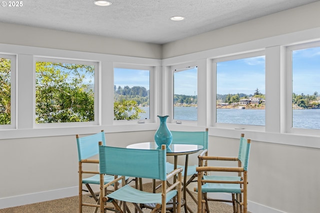 2941 NE Loop Dr, Otis, OR 97368 - sunroom with baseboards, a textured ceiling, recessed lighting, and a water view