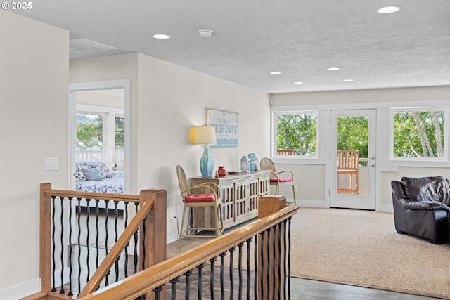2941 NE Loop Dr, Otis, OR 97368 - corridor featuring recessed lighting, baseboards, a textured ceiling, and carpet