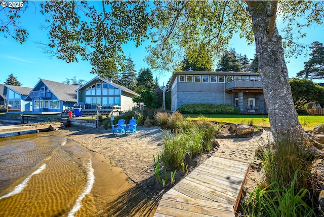 2941 NE Loop Dr, Otis, OR 97368 - back of house with board and batten siding, stone siding, and a wooden deck