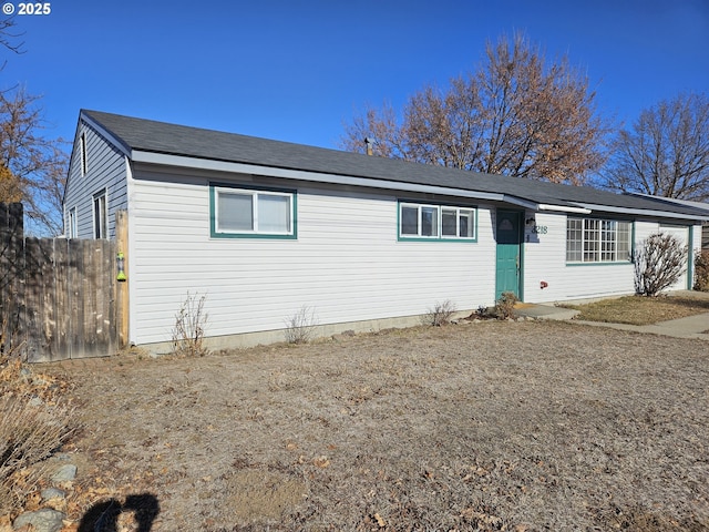 ranch-style house featuring fence