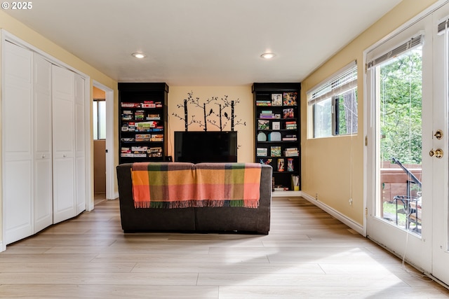 living area featuring light wood-style flooring and recessed lighting