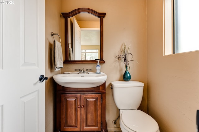 half bathroom with toilet and vanity