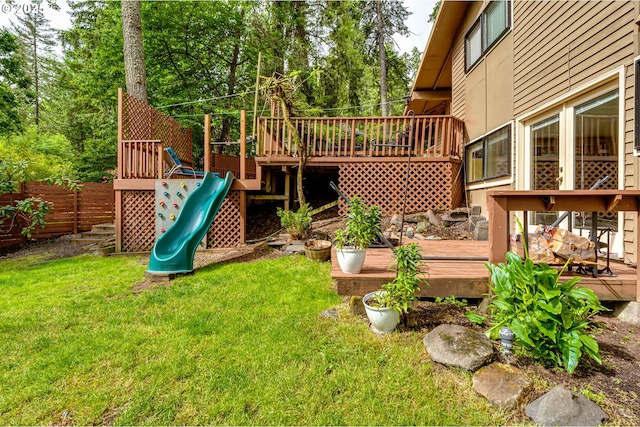 view of playground with a wooden deck