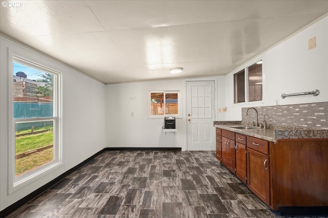 1209 NW 53rd St, Vancouver, WA 98663 - kitchen featuring a sink, decorative backsplash, brown cabinetry, stone countertops, and glass insert cabinets