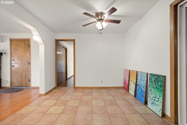 1209 NW 53rd St, Vancouver, WA 98663 - empty room featuring arched walkways, ceiling fan, and baseboards