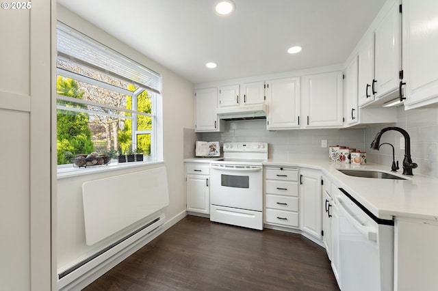 kitchen with baseboard heating, white appliances, sink, and white cabinets