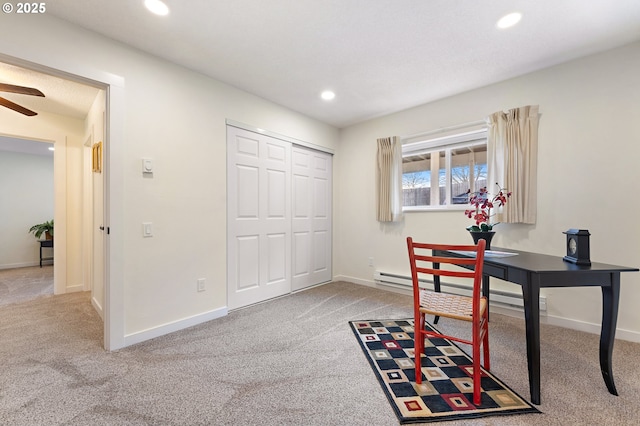 carpeted office space featuring ceiling fan