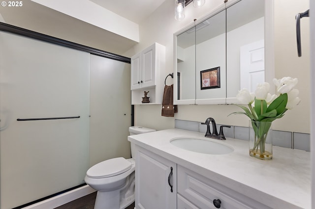 bathroom featuring vanity and toilet