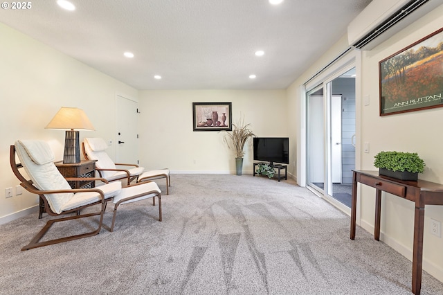 sitting room with carpet flooring and a wall mounted AC