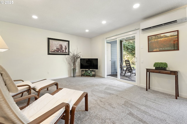 living room with an AC wall unit, light colored carpet, and a textured ceiling