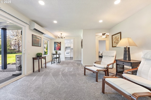 sitting room with light carpet, a wall mounted air conditioner, ceiling fan with notable chandelier, and a textured ceiling