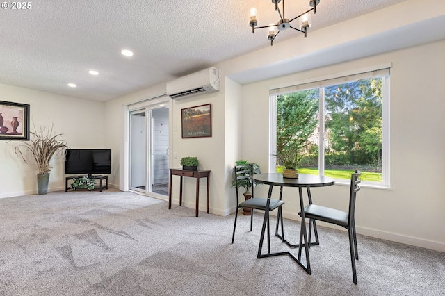 sitting room featuring plenty of natural light, carpet flooring, a textured ceiling, and a wall unit AC