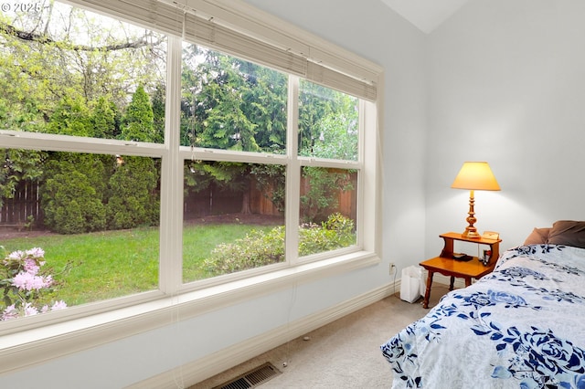 carpeted bedroom with baseboards and visible vents