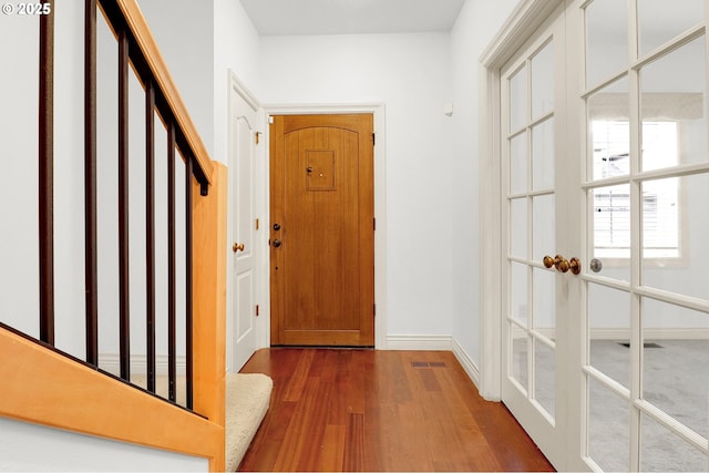 interior space with baseboards, french doors, and dark wood-style flooring