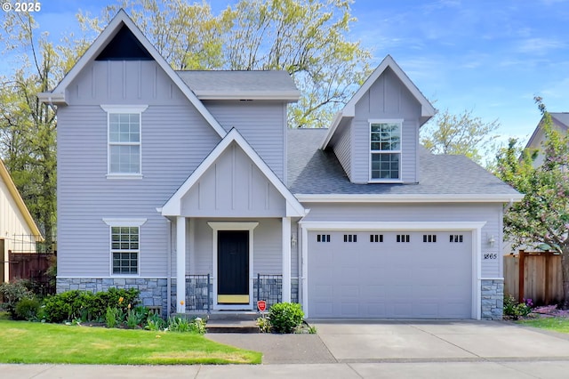 view of front facade with a garage, board and batten siding, stone siding, and concrete driveway