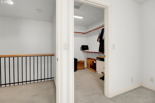 walk in closet featuring carpet flooring