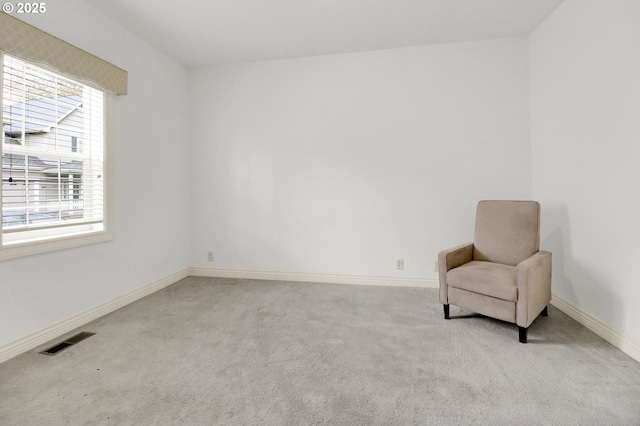 unfurnished room with carpet floors, baseboards, and visible vents
