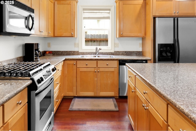 kitchen featuring dark wood-style flooring, appliances with stainless steel finishes, and a sink