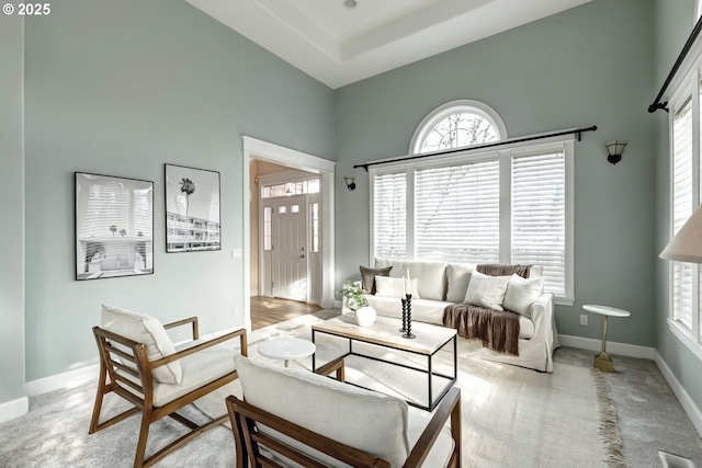 14606 NW Applegate Ln, Portland, OR 97229 - living area featuring baseboards, light colored carpet, and a towering ceiling