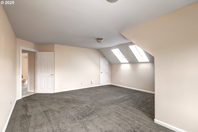 14606 NW Applegate Ln, Portland, OR 97229 - additional living space with baseboards, dark carpet, and lofted ceiling with skylight