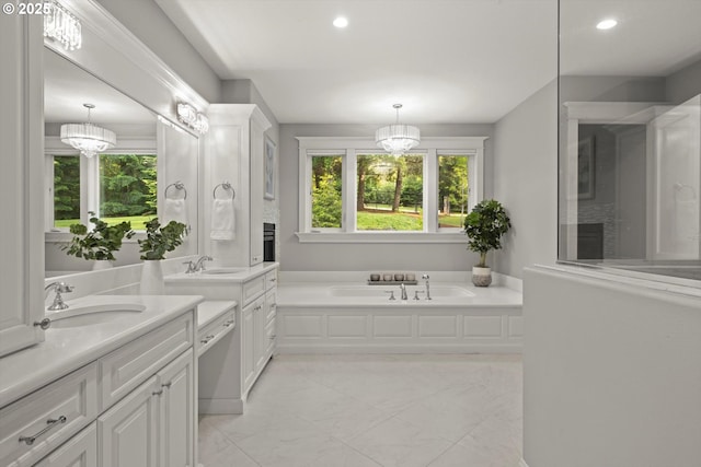 28800 SW Wildhaven Ln, Hillsboro, OR 97123 - bathroom featuring two vanities, healthy amount of natural light, a bath, recessed lighting, and marble finish floors