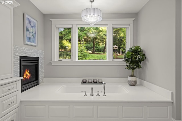 28800 SW Wildhaven Ln, Hillsboro, OR 97123 - bathroom featuring a chandelier, a tile fireplace, and a bath