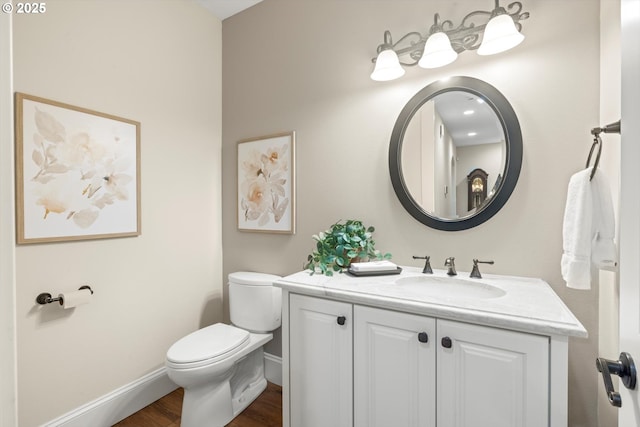 28800 SW Wildhaven Ln, Hillsboro, OR 97123 - bathroom with vanity, toilet, baseboards, and wood finished floors