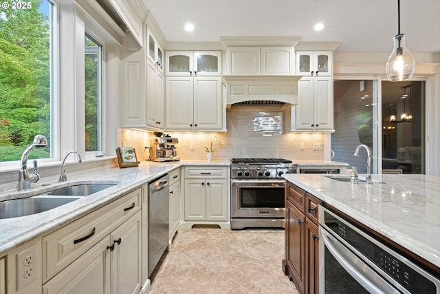 28800 SW Wildhaven Ln, Hillsboro, OR 97123 - kitchen featuring appliances with stainless steel finishes, a sink, tasteful backsplash, light stone countertops, and recessed lighting