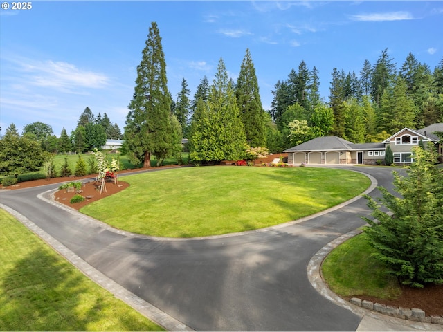 28800 SW Wildhaven Ln, Hillsboro, OR 97123 - view of grassy yard with driveway and an attached garage