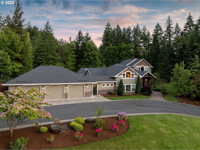28800 SW Wildhaven Ln, Hillsboro, OR 97123 - view of front of home with an attached garage, driveway, stone siding, and a yard