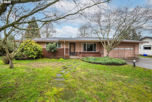 ranch-style house featuring covered porch, a front lawn, and a garage