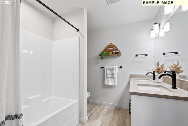 bathroom with hardwood / wood-style floors, vanity, and toilet