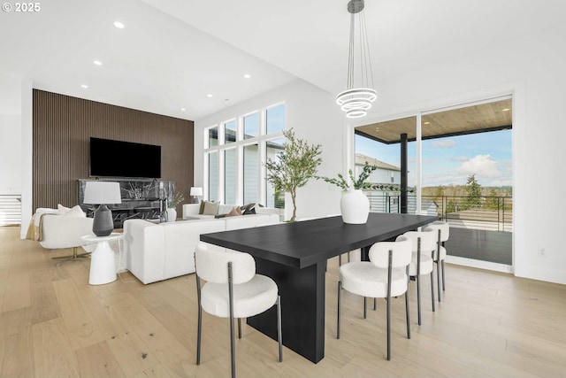 dining space with an inviting chandelier and light hardwood / wood-style flooring