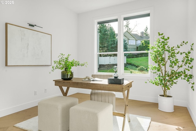 office featuring wood-type flooring and a healthy amount of sunlight