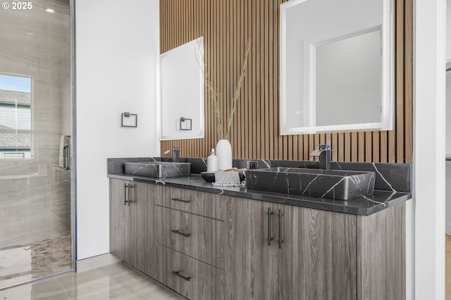 bathroom with vanity and a shower with shower door