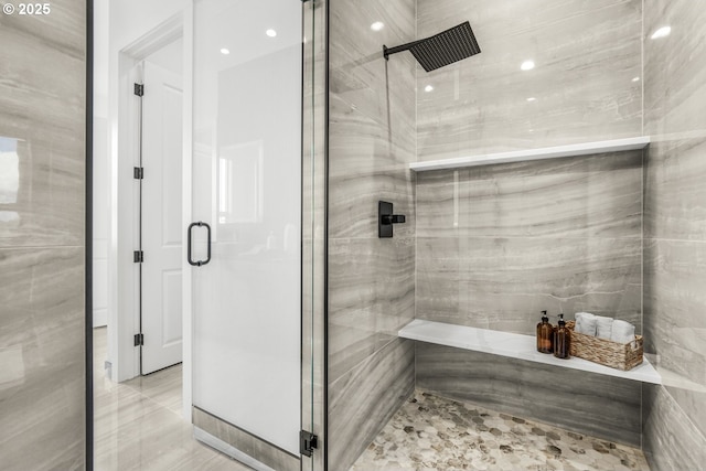 bathroom featuring a shower with door