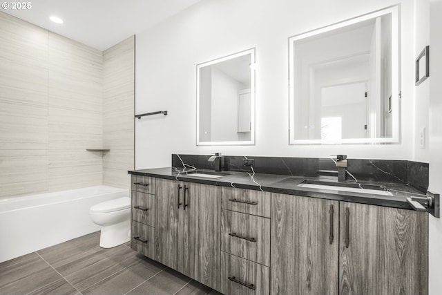 full bathroom with vanity, toilet, and tiled shower / bath combo