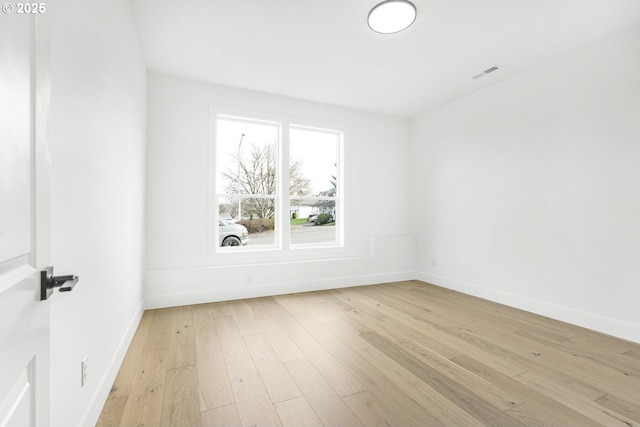 spare room featuring light hardwood / wood-style flooring