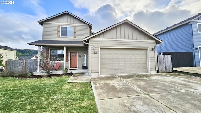 view of front of house featuring a porch, a garage, and a front yard