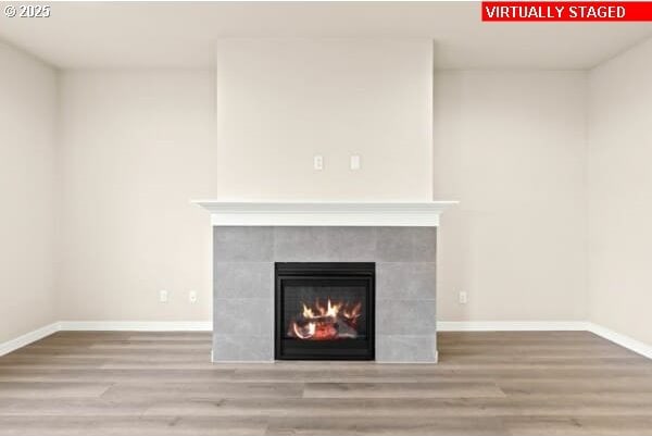 10587 SE Webelos Way, Happy Valley, OR 97086 - detailed view of wood finished floors and a tiled fireplace