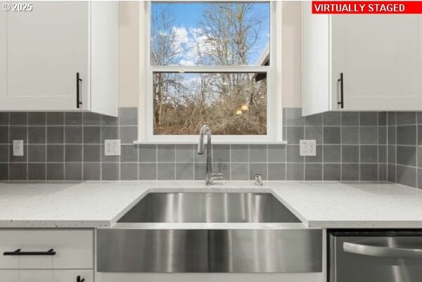 10587 SE Webelos Way, Happy Valley, OR 97086 - kitchen featuring dishwasher, white cabinets, decorative backsplash, and light stone countertops