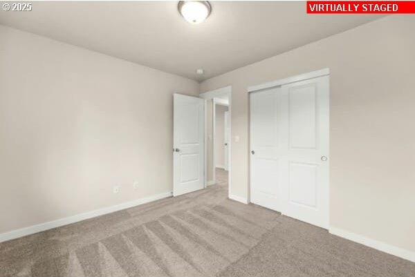 10587 SE Webelos Way, Happy Valley, OR 97086 - unfurnished bedroom with carpet floors and a closet