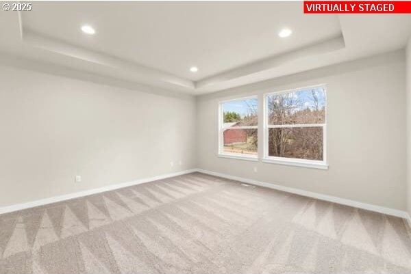 10587 SE Webelos Way, Happy Valley, OR 97086 - unfurnished room featuring a tray ceiling, carpet floors, and recessed lighting