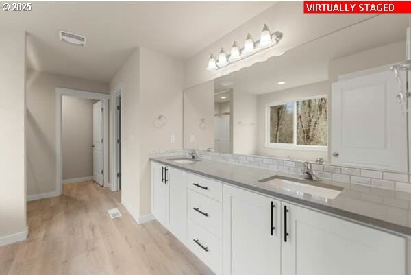 10587 SE Webelos Way, Happy Valley, OR 97086 - full bathroom featuring wood finished floors and double vanity