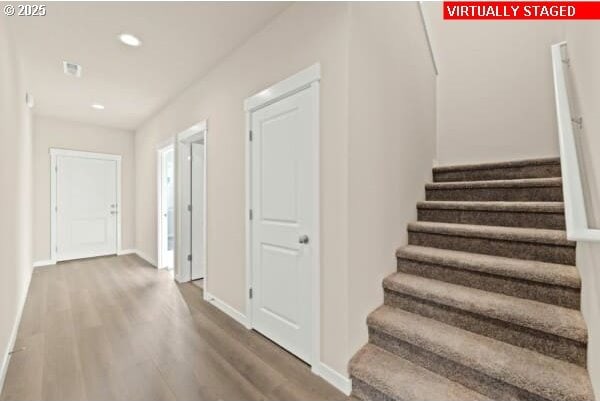 10587 SE Webelos Way, Happy Valley, OR 97086 - staircase with wood finished floors and recessed lighting