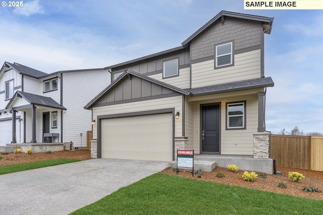 view of front of house featuring board and batten siding, concrete driveway, an attached garage, and fence