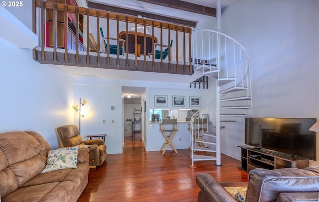 43605 State Highway 38 Unit 41, Reedsport, OR 97467 - living room featuring stairway, wood finished floors, a high ceiling, and beamed ceiling